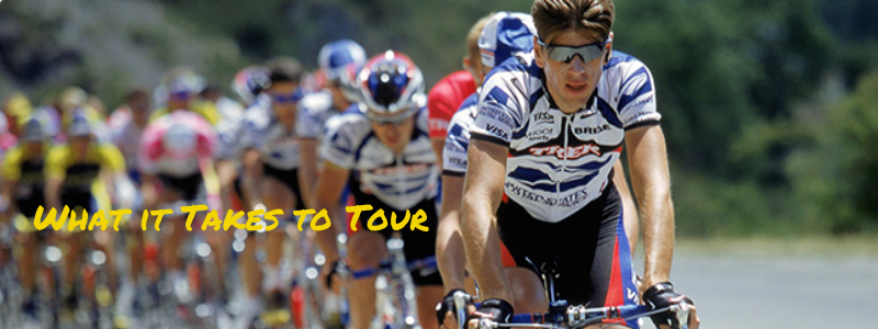 Frankie Andreu Cycling at the front of a race, text "What it Takes to Tour"