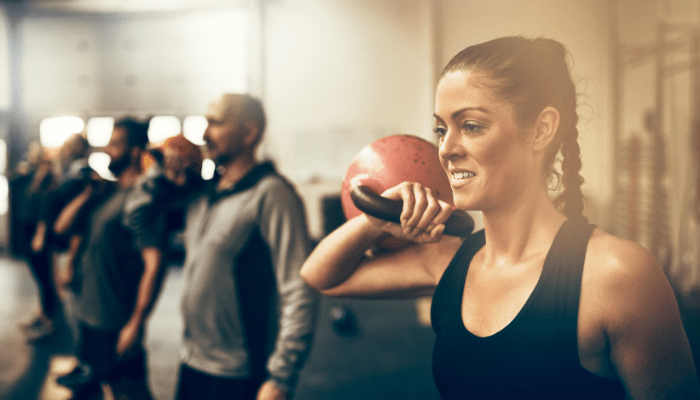 Woman in an exercise class holding a kettlebell